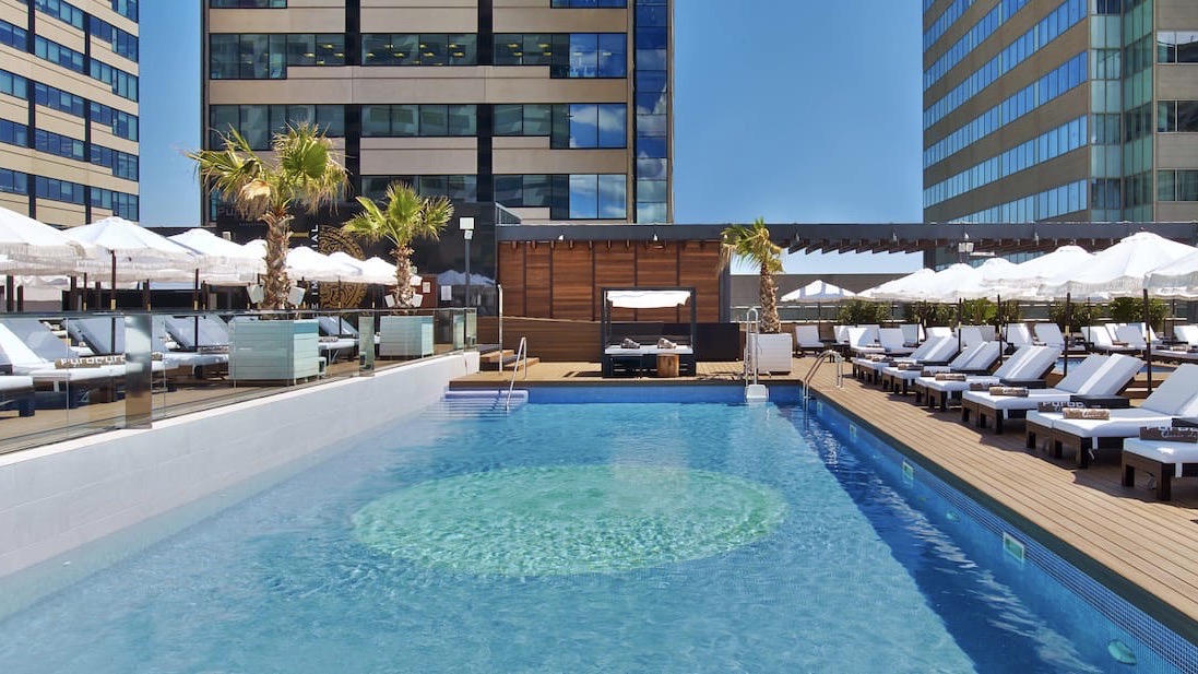 hilton diagonal mar bcn swimming pool and seating of one ofm the coolest hotels in barcelona spainjpeg